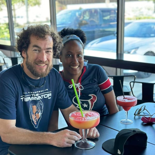 Smiling couple enjoying daiquiris at Retreats New Orleans Style Daiquiris & Eats.